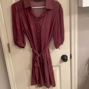 It has pockets!! Size medium, wine colored button down dress with tie belt.